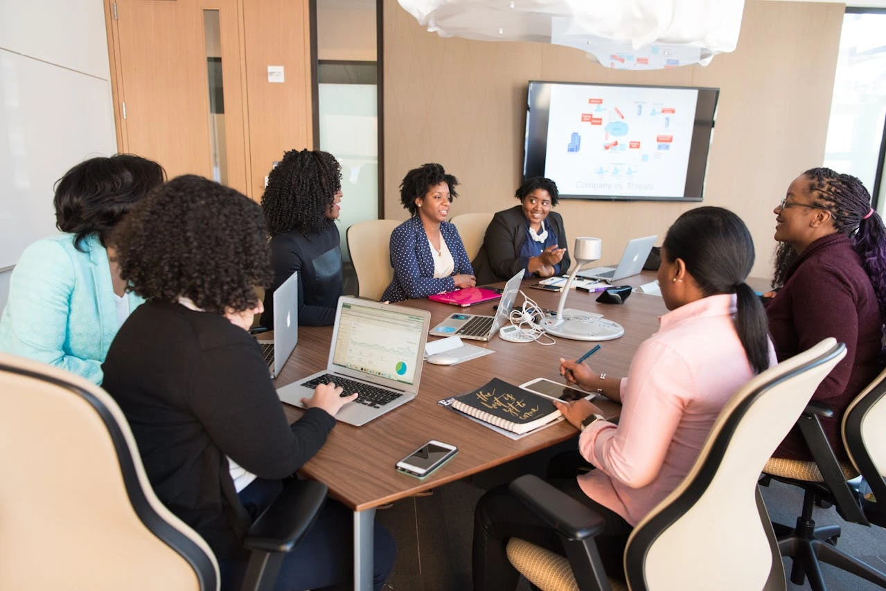 Group of executives discussing AI strategy and business goals, focusing on responsible AI, AI regulations, and aligning AI with company objectives.